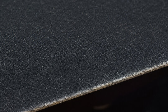 Black Skateboard Grip Tape Surface. A close up of rough abrasive material representing grit and mental preparation before an intense sporting challenge
