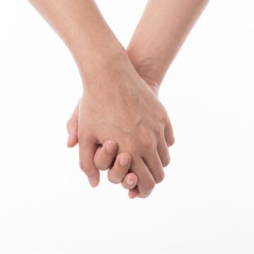 hand to hand holding with fingers interlocked showing affection isolated on white