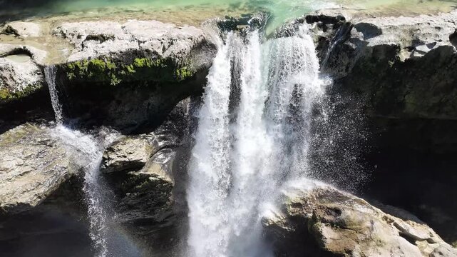 Martvili canyon waterfall flowing over rocky cliffs with emerald water, scenic nature landscape, travel Georgia, water power