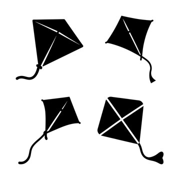 Four black kites flying in sky - Simple vector illustration of four black diamond-shaped kites flying upward in an open sky.