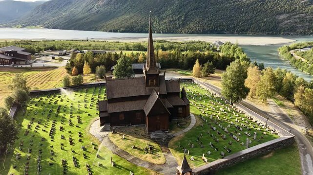 Scenic aerial view of historic Lom Stave Church illuminated by warm sunset light in Norway