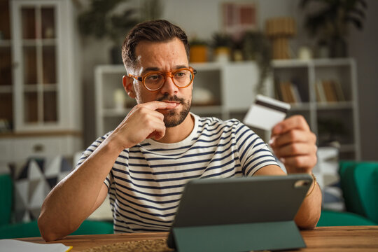 Man thinking about online shopping and credit card debt