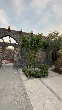 Courtyard and stone arches of the historic Masjid Bani Anif in Medina.