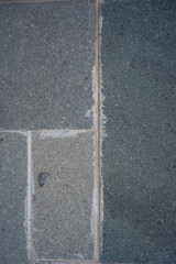 Fototapeta premium Dark stone tiles line a paved surface