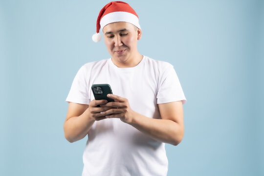 Young cheerful man text messaging on his mobile phone smartphone