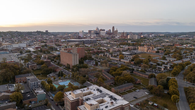Aerial view of city skyline during golden sunset dusk hour over buildings