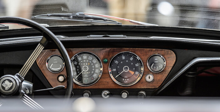 Gothenburg, Sweden - May 30 2026: Classic Triumph Spitfire dashboard viewed through windshield with soft reflections.