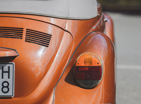Gothenburg, Sweden - May 30 2026: Close rear detail of bronze Volkswagen Beetle convertible tail light.