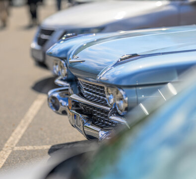 Gothenburg, Sweden - May 30 2026: Close view of vintage Cadillac chrome grille and blue hood.