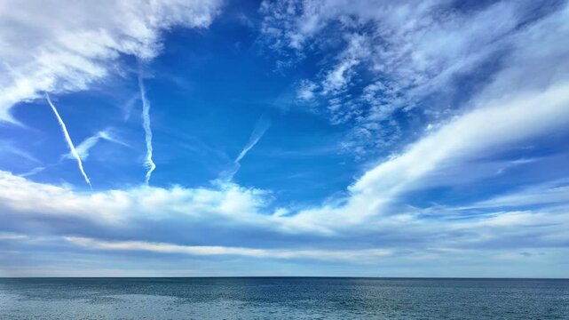Timelapse over batumi black sea reveals streaked clouds drifting across a bright blue sky.