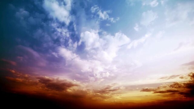 Vibrant and dramatic sky with colorful clouds at sunrise or sunset, showcasing a gradient of blue, purple, orange, and red hues.