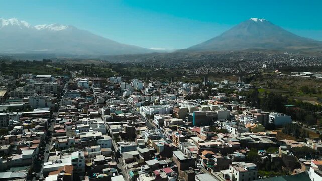 Beautiful drone flight over the historic city of Arequipa in Peru with panoramic views of active and dormant volcanoes.