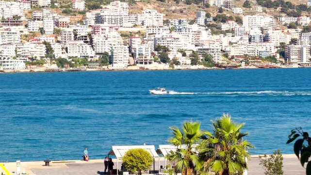 Speedboat Cruising On Blue Sea Water Near Coastal Resort City. Mediterranean Summer Vacation