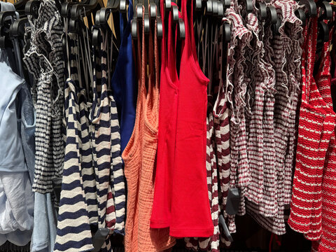Colorful Summer Dresses And Fashion Tops Hanging Inside Modern Boutique Clothing Store