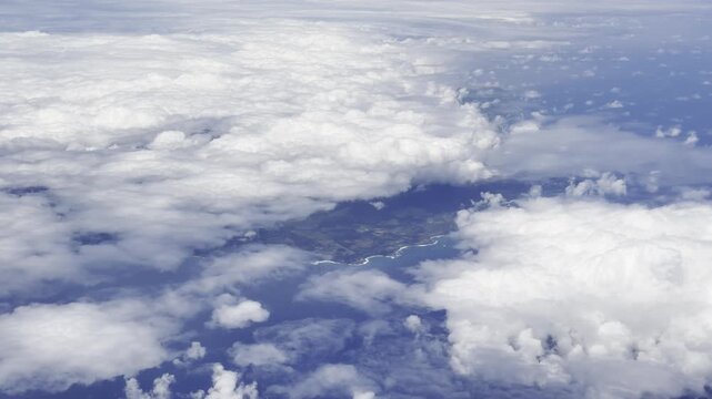 Above the clouds. Kauai is in the distance. Flights from Daniel K. Inouye International Airport in Honolulu, Oahu, Hawaii, to Narita Airport in Tokyo, Japan. The Airbus A380