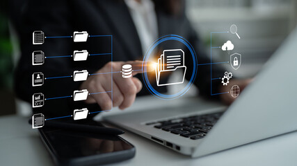 Naklejka na ściany i meble Business Professional Engaging with Digital File Management System on Laptop with Modern Interface Icons in Background. Glyphic.
