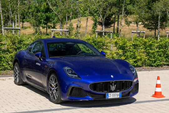 Arlon, Belgium - June 22nd 2026 : View on a blue Maserati GranTurismo Trofeo parked on a parking lot with trees in the background.