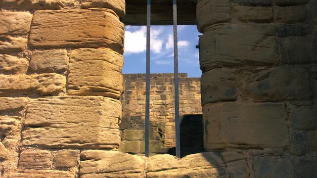 Prison bars on a stone wall