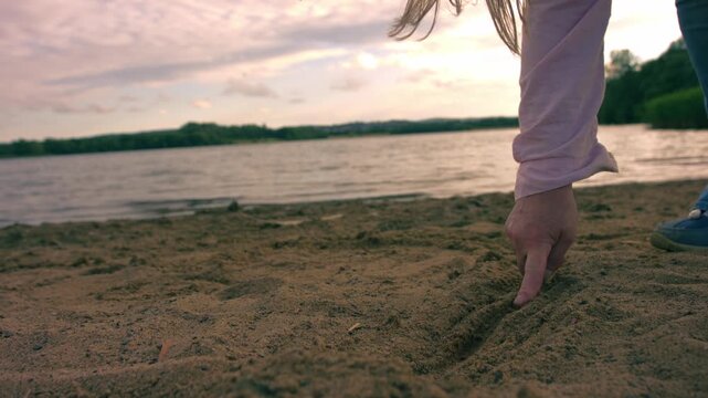 Woman drawing a line in the sand at beach