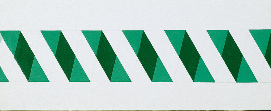 Stack of green paper sheets with diagonal cut edges. Abstract geometric office supplies for design and print projects.