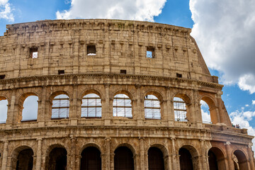 Fototapeta premium Famous tourist attraction of historic Colosseum amphitheatre with ancient stone arches in Rome Italy