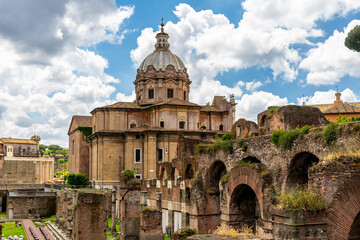 Fototapeta premium Ancient ruins of the Roman Forum and the church of Santi Luca e Martina in Rome Italy