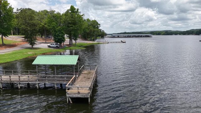 Aerial View of a Boat Dock with Green Roof on the Lake in Scottsboro, Alabama