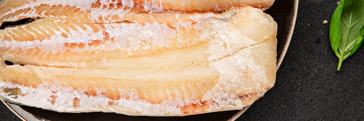 Obraz premium Frozen fish seafood&nbsp;white fish fillet pescetarian diet tasty snack fresh and delicious gourmet food background on the table rustic food top view copy space keto and paleo diet