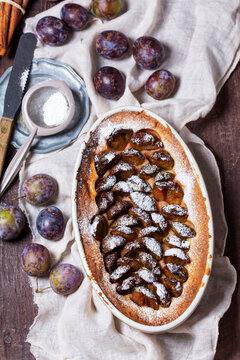 German plum cake with cinnamon, served with ice cream and coffee.