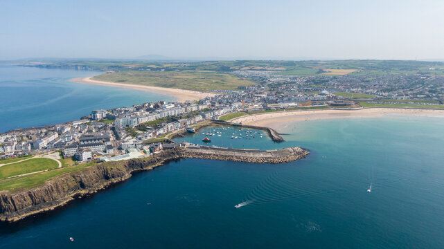 Aerial View of Portrush West Strand Beach and Harbor in Northern Ireland. Drone Shot of Scenic Coastal Bay and Turquoise Waters