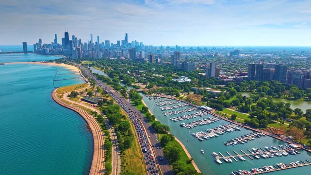 Moving over Lake Michigan waterfront with sandy beach and busy highways. Heading to the city center of Chicago, Illinois, USA.