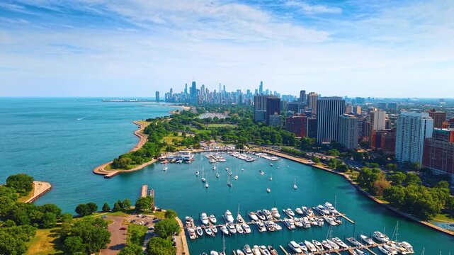 Lagoon with multiple boats and yachts at the berths. Drone footage over the picturesque waterfront of Lake Michigan in Chicago, Illinois, USA.