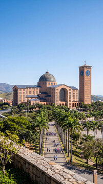 The majestic Basilica of the Shrine of Our Lady of Aparecida in Brazil, surrounded by palm trees with pilgrims walking along the path on a sunny day.