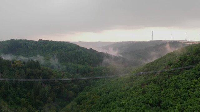 Geierlay suspension bridge crossing foggy Hunsr&uuml;ck valley