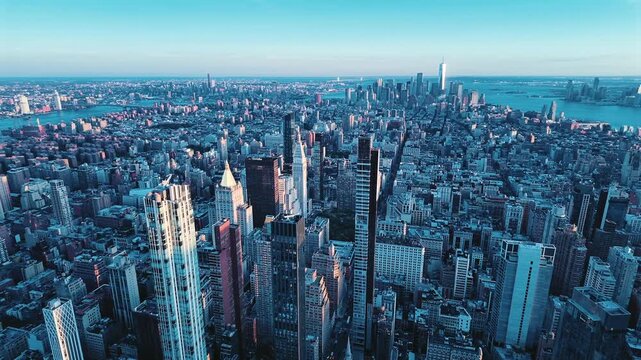 A pan shot of New York City's massive buildings in the late afternoon