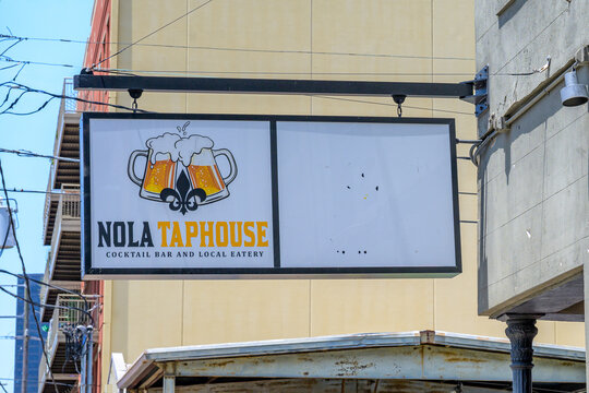 New Orleans, LA, USA - July 3, 2026: Nola Taphouse Sign on the  corner of the Historic Pub in the Warehouse District