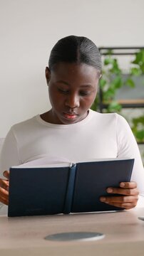 Young focused african american student preparing for exams in class