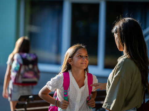 Mom and daughter share a joyful moment after school