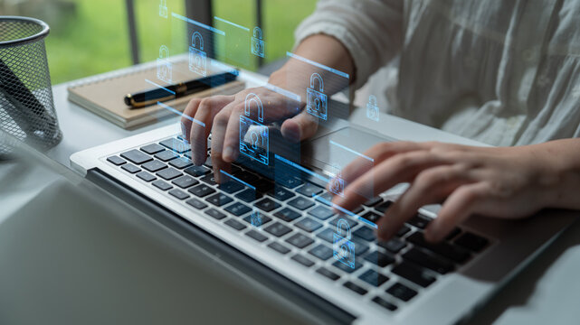 Hands Typing on Laptop Keyboard with Digital Lock Icons Illustrating Cybersecurity Protection Concept in Modern Workspace. Entropy.