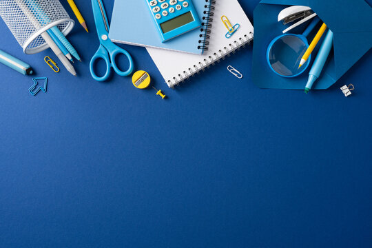 Back to school flat lay with blue stationery and school supplies on a clean desk