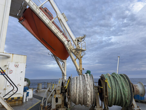 life saving appliances on board the cargo ship. free fall life boat. mooring winches with ropes.