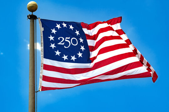 Official America 250 Flag Fluttering In Bright Blue Sky During National Anniversary Celebration In America