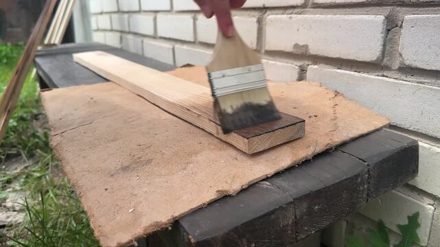 Coating sanded boards with dark varnish . High quality 4k footage