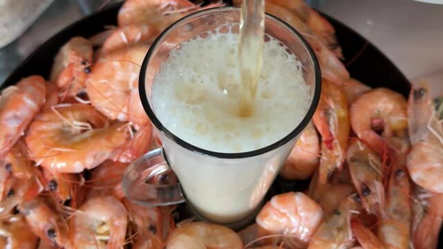 Cold draft beer with a creamy foam pairs perfectly with freshly cooked shrimp for a classic seafood snack. An inviting combination for relaxing evenings, movies, sports and casual gatherings.