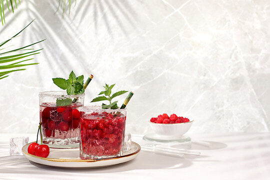 Mojito with sprite, mint and fresh berries,Detox water with raspberries, cherries, and currants, over ice. A refreshing summer homemade lemonade cocktail. Fruit juice and ingredients,