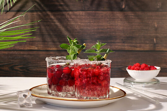 Mojito with sprite, mint and fresh berries,Detox water with raspberries, cherries, and currants, over ice. A refreshing summer homemade lemonade cocktail. Fruit juice and ingredients,