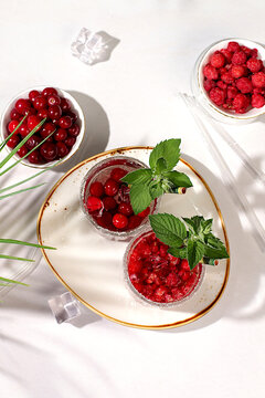 Mojito with sprite, mint and fresh berries,Detox water with raspberries, cherries, and currants, over ice. A refreshing summer homemade lemonade cocktail. Fruit juice and ingredients,