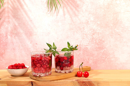 Mojito with sprite, mint and fresh berries,Detox water with raspberries, cherries, and currants, over ice. A refreshing summer homemade lemonade cocktail. Fruit juice and ingredients,
