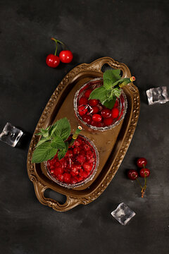 Mojito with sprite, mint and fresh berries,Detox water with raspberries, cherries, and currants, over ice. A refreshing summer homemade lemonade cocktail. Fruit juice and ingredients,