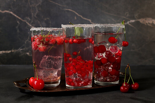 Dietary vegan water with raspberries, currants, and cherries, detox water, mojito with Sprite, mint, and fresh berries. Detox diet and weight loss concept, healthy lifestyle advertising,